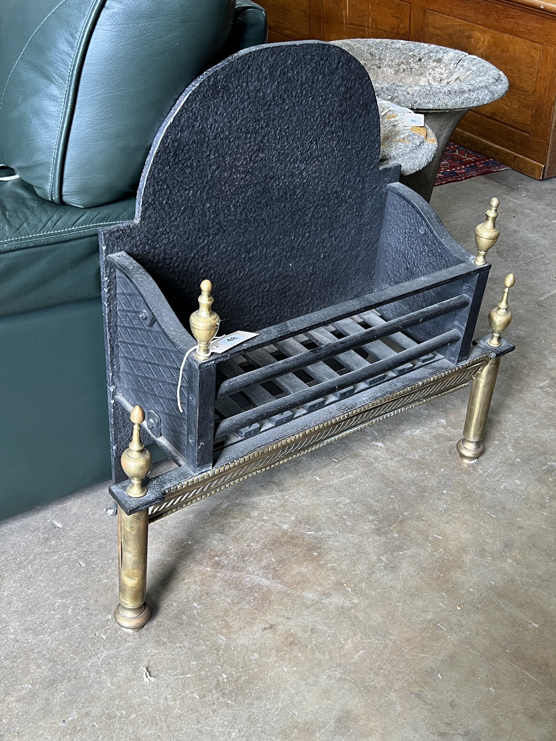 A brass mounted cast iron fire grate, width 71cm, depth 24cm, height 70cm